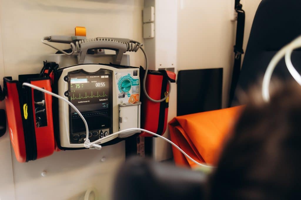 defibrillator on the table in the hospital near the patient's bed.